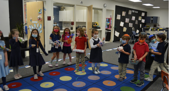 Students experiment with musical sounds by the musical instruments they created during their sound and hearing unit.