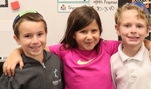 students with arms over each other group photo