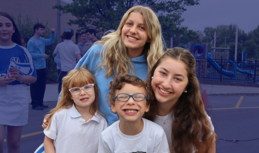 students hugging and smiling in outside