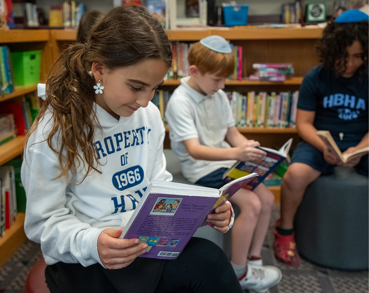 students reading books on floor
